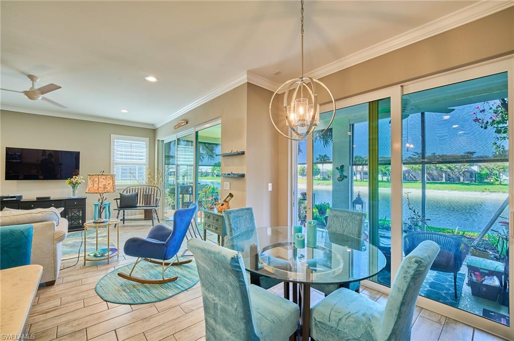 2319 Sawyers Hill Road, Unit 701 Naples, FL 34120 - Photo 10 of 36 a living room with furniture a flat screen tv and floor to ceiling window