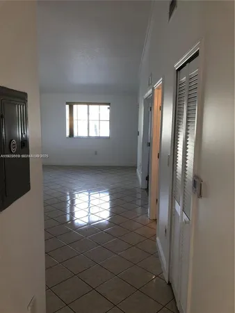 a bathroom with windows and chandelier