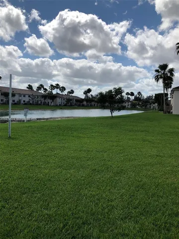 a view of field with an house in background