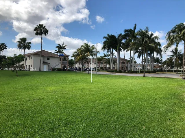 a view of a park with palm trees