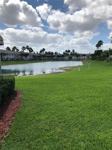 a view of a lake with houses in the back