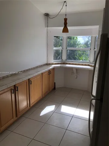 a kitchen with stainless steel appliances granite countertop a sink and a window