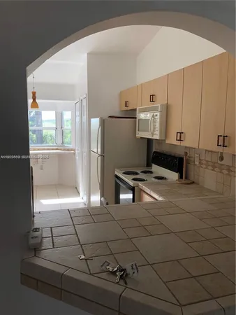 a kitchen with stainless steel appliances a refrigerator and a stove