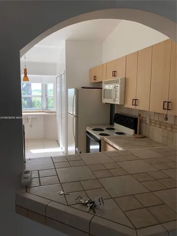 a kitchen with stainless steel appliances a refrigerator and a stove