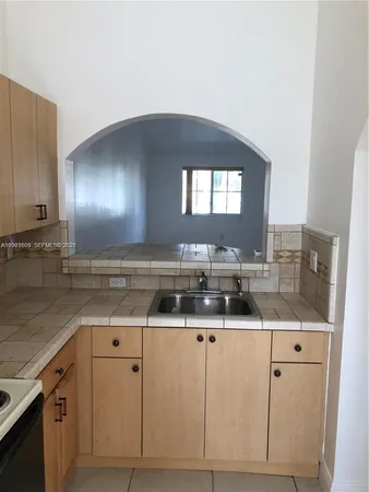 a kitchen with cabinets a sink and appliances