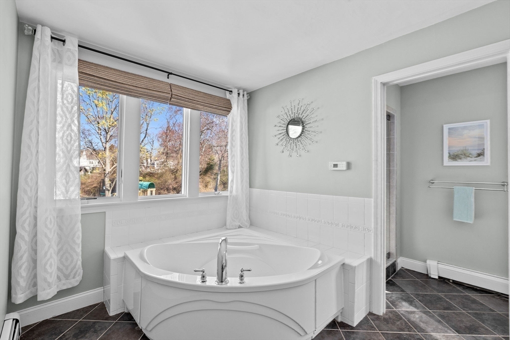 18 Hatherly Road Scituate, MA 02066 - Photo 19 of 42 a white bath tub sitting in a bathroom next to a window