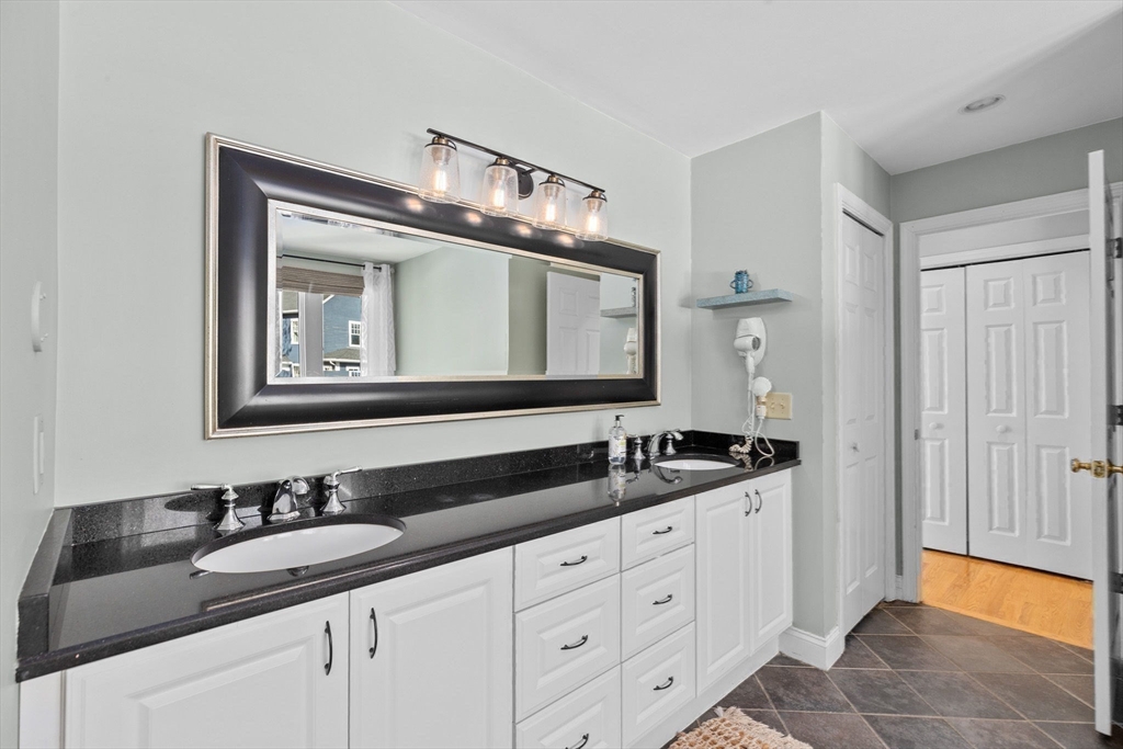 18 Hatherly Road Scituate, MA 02066 - Photo 20 of 42 a bathroom with a double vanity sink and mirror
