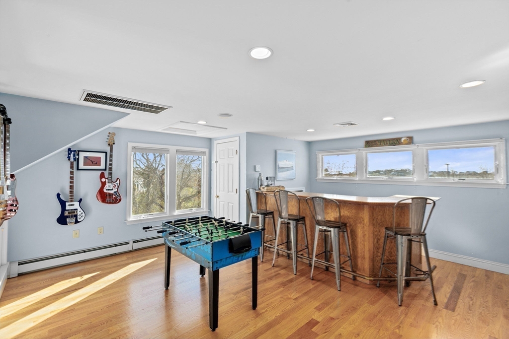 18 Hatherly Road Scituate, MA 02066 - Photo 29 of 42 a dining hall with stainless steel appliances granite countertop a dining table and chairs with wooden floor