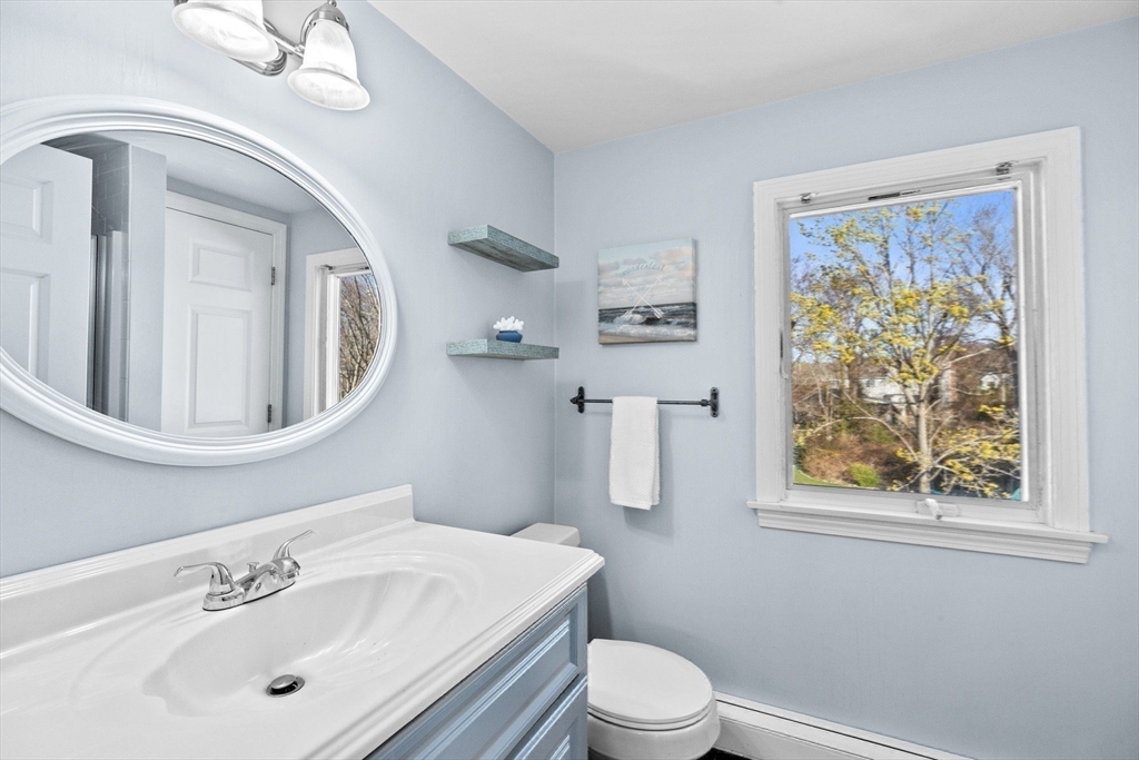18 Hatherly Road Scituate, MA 02066 - Photo 30 of 42 a bathroom with a toilet a sink a mirror and a window