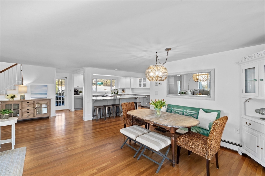 18 Hatherly Road Scituate, MA 02066 - Photo 5 of 42 a dining room with wooden floor a chandelier a wooden table and chairs