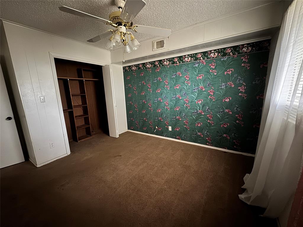 3909 Smothers Road Caney City, TX 75148 - Photo 21 of 35 an empty room with wooden floor and fan