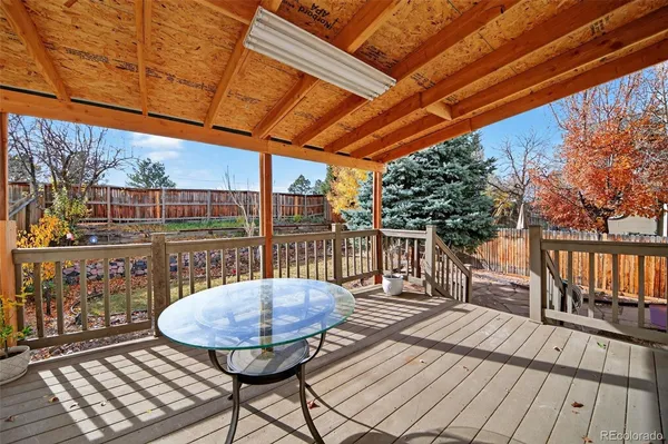 a backyard of a house with fountain table and chairs