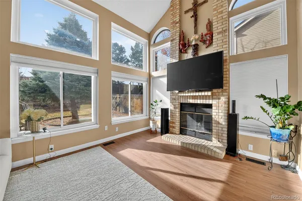 a living room with fireplace furniture and a flat screen tv