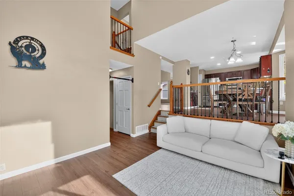 a living room with furniture and a book shelf
