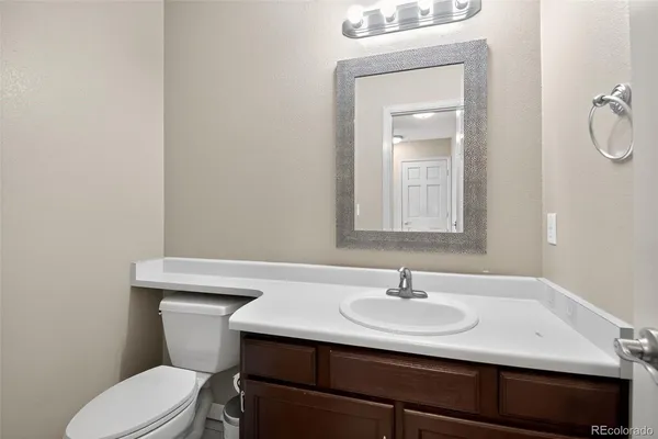 a bathroom with a sink toilet and mirror