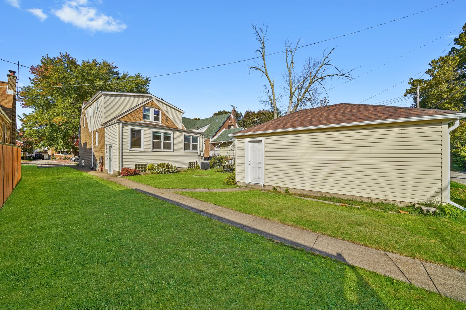 13115 South Escanaba Avenue Chicago, IL 60633 - Photo 18 of 24 a front view of a house with a yard