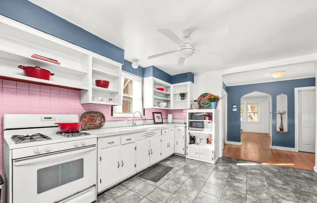 a kitchen with a sink dishwasher and white cabinets