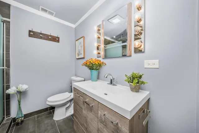 a bathroom with a sink toilet and a mirror