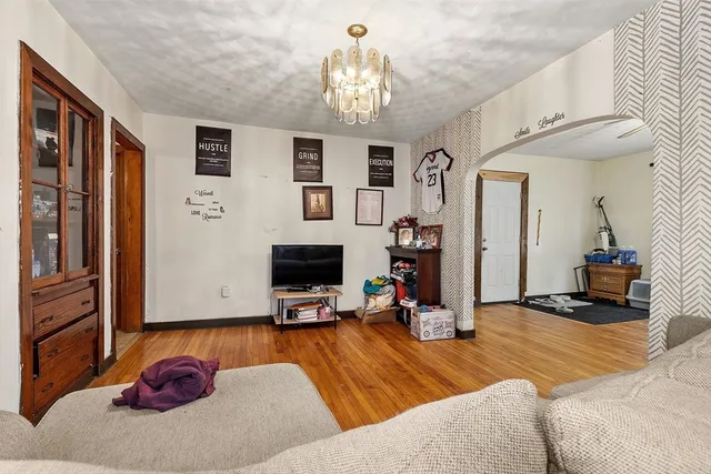 a bedroom with furniture and a chandelier