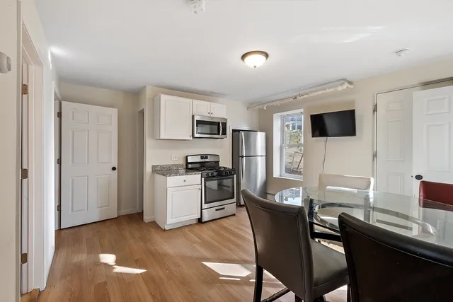 a view of a dining room with furniture and a window