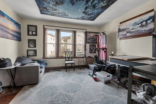 a view of a livingroom with workspace and a window