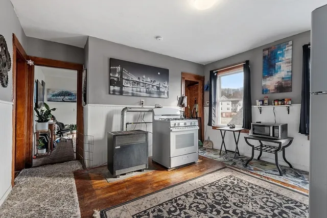a living room with furniture a rug and white walls