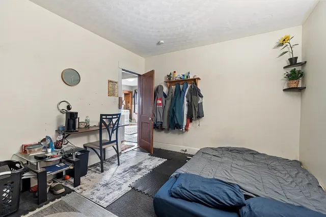 a bedroom with furniture and a gym equipment