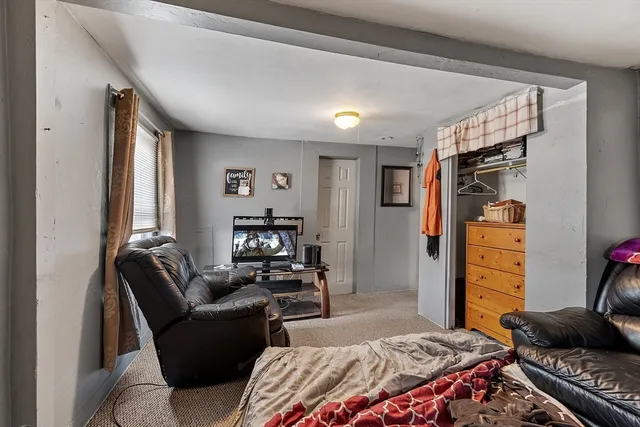 a bedroom with furniture and a closet