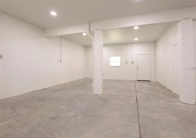 an empty room with an entryway and shower