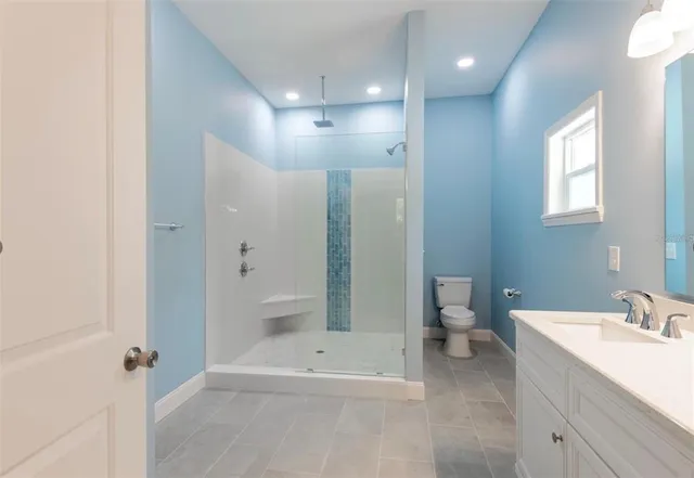 a bathroom with a bathtub shower sink and toilet