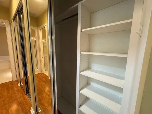 a view of bedroom with wooden floor