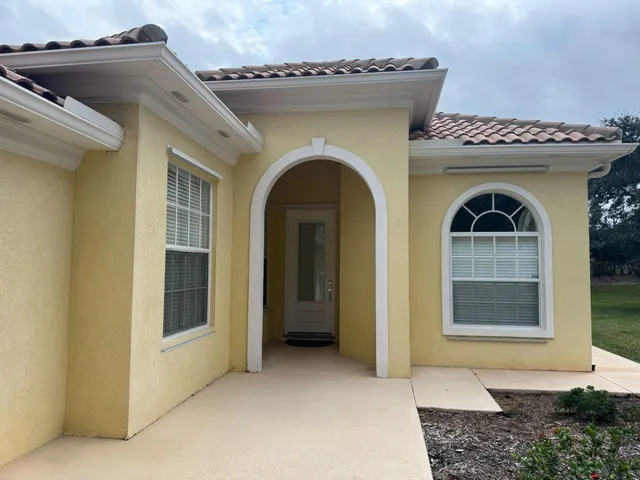 a view of a room with wooden floor and a tub