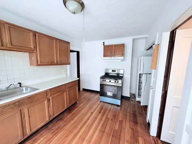 a kitchen with stainless steel appliances a refrigerator and a sink