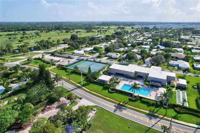 an aerial view of residential houses with outdoor space and river