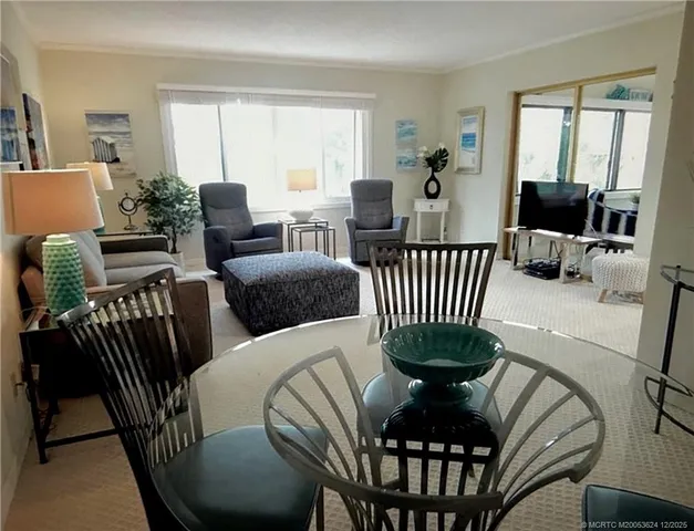 a view of a dining room with furniture window and outside view