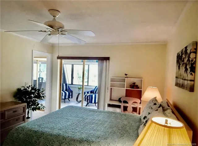 a bed room with a bed and a chair