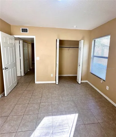 a bathroom with a toilet a sink a mirror and vanity