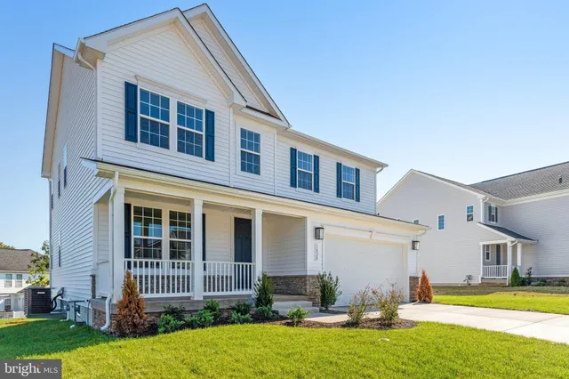 a front view of a house with swimming pool having outdoor seating