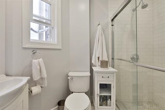 215 Adams Street, Unit 2L Hoboken, NJ 07030 - Photo 11 of 12 a bathroom with a toilet sink and mirror