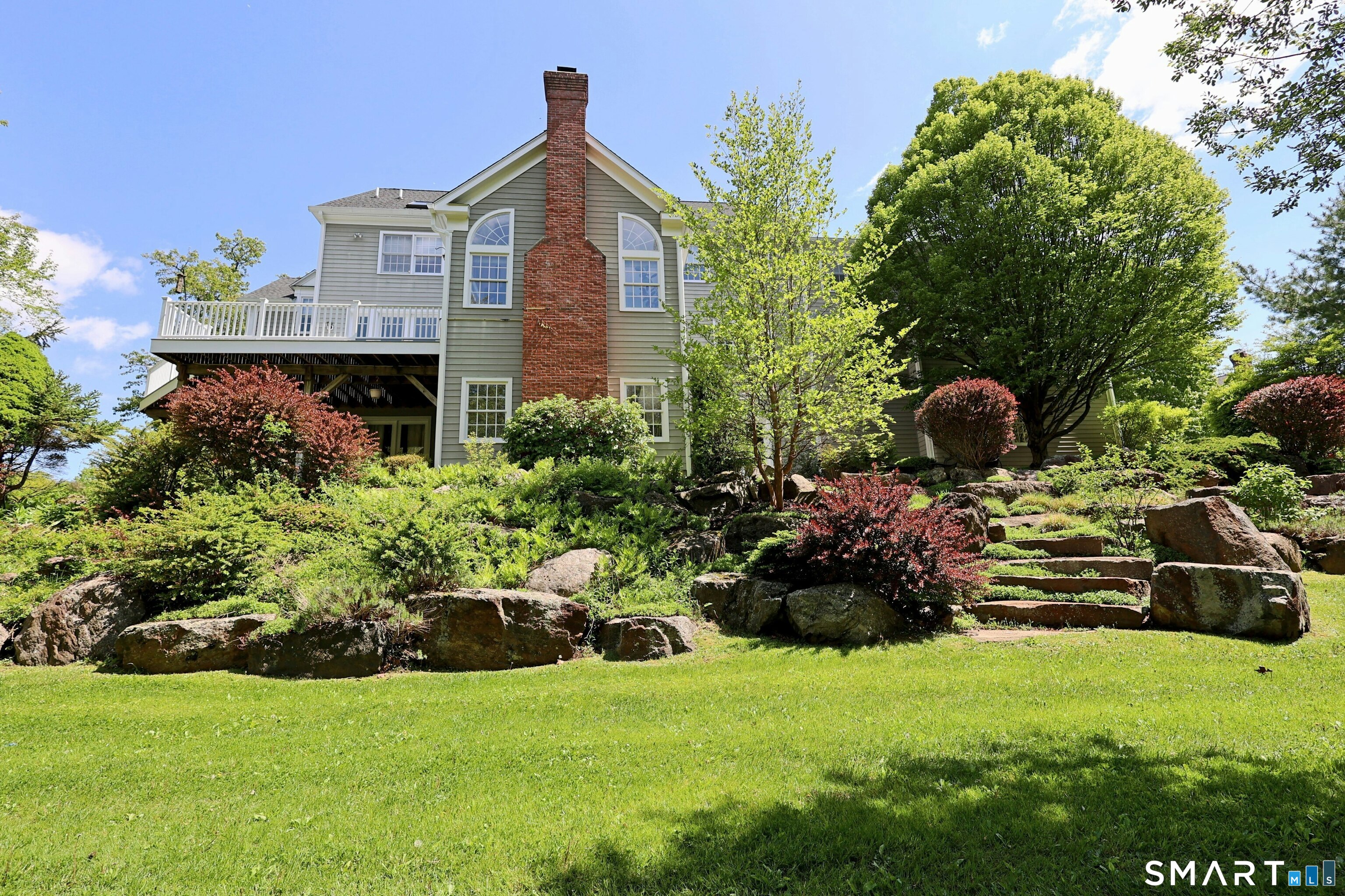 30 Whipstick Road Ridgefield, CT 06877 - Photo 5 of 40 a front view of a house with a garden