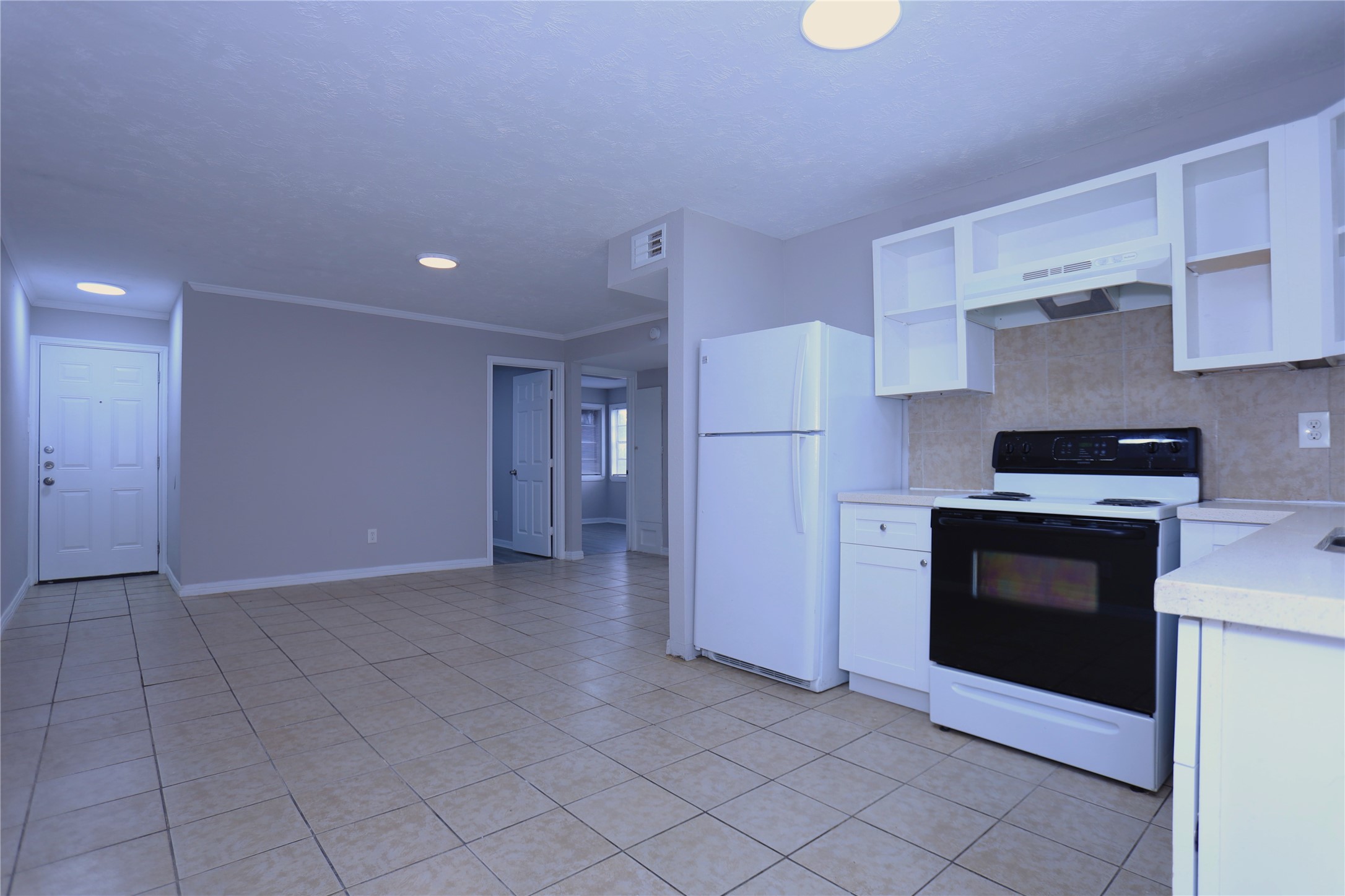 123 West 6th Street, Unit 2 Freeport, TX 77541 - Photo 3 of 8 a kitchen with a stove and a refrigerator