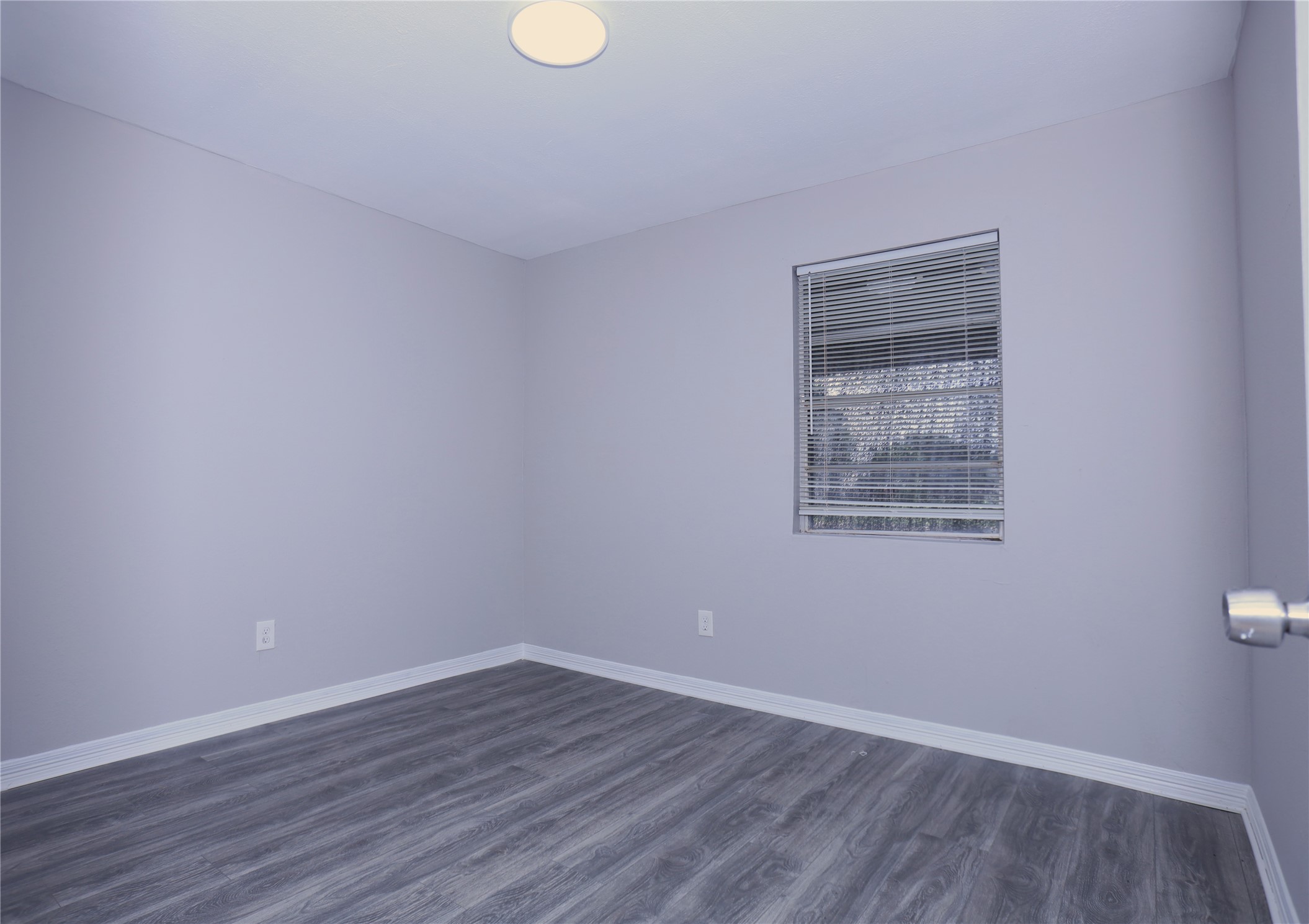 123 West 6th Street, Unit 2 Freeport, TX 77541 - Photo 6 of 8 a view of an empty room with wooden floor and a window