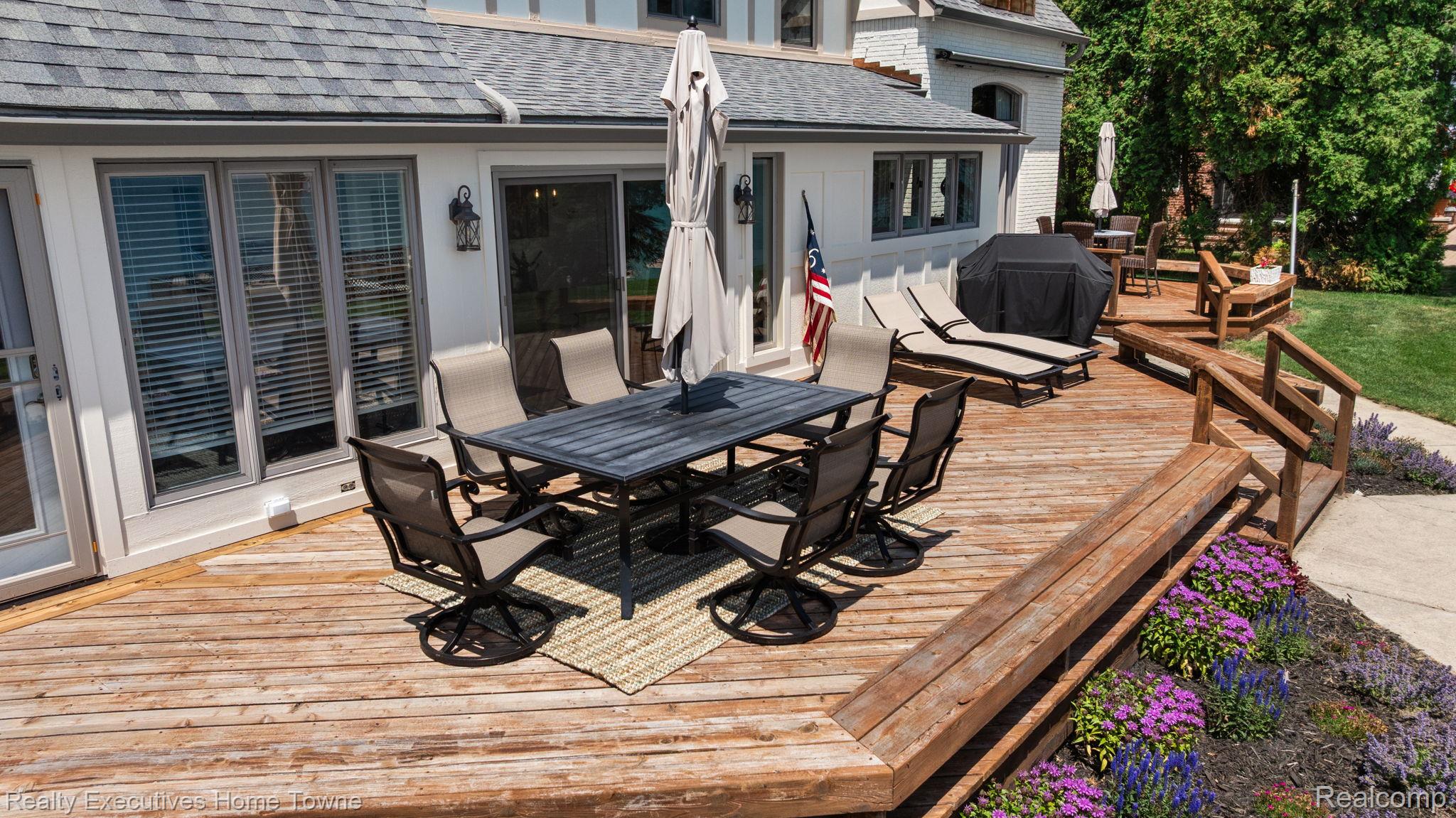8308 Lakeshore Road Fort Gratiot, MI 48059 - Photo 10 of 79 Multi-level wood deck featuring a dining area, lounge space, and a ramp access point