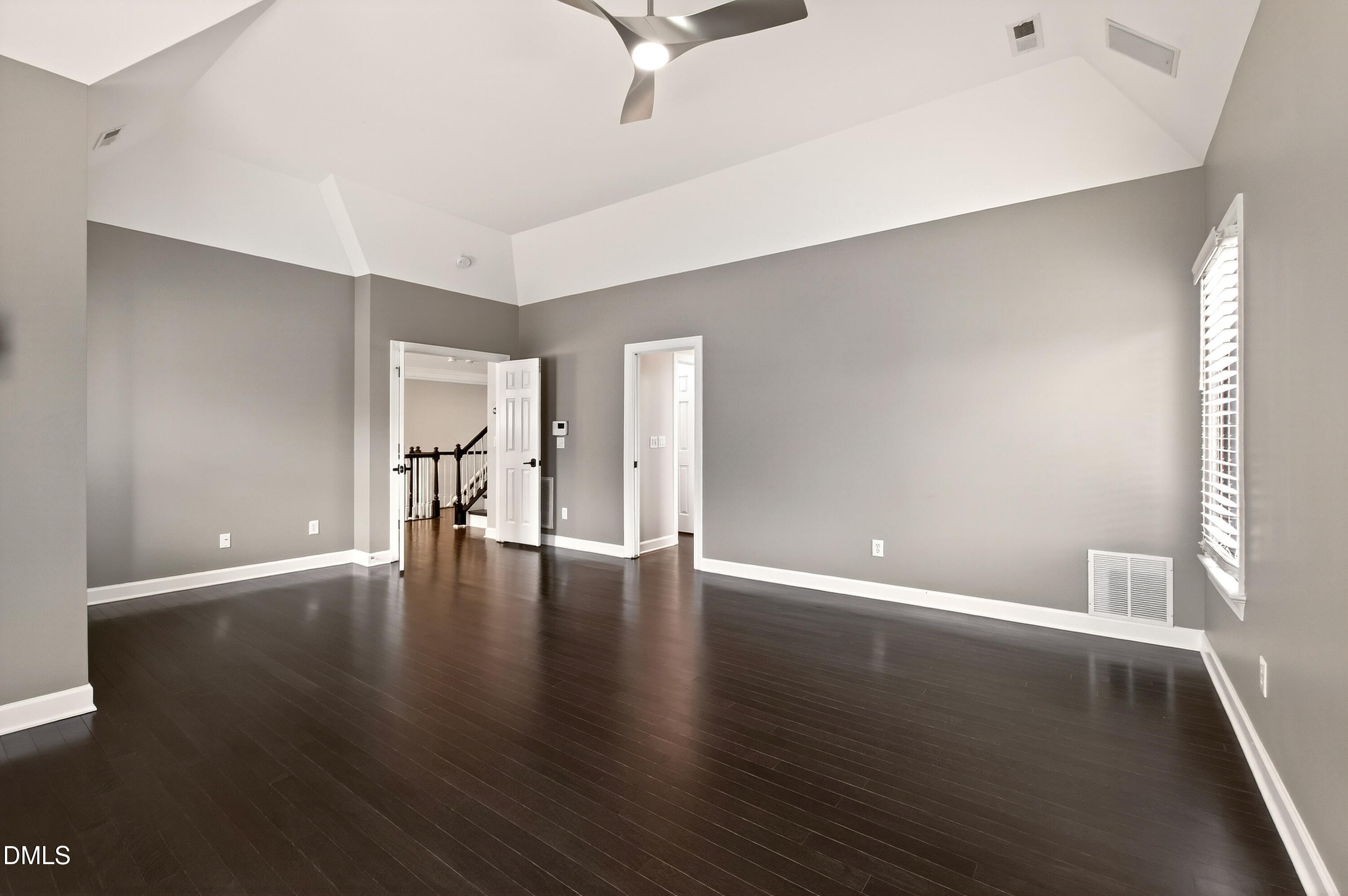 12408 Cilcain Court Raleigh, NC 27614 - Photo 44 of 80 a view of an empty room with wooden floor and a window