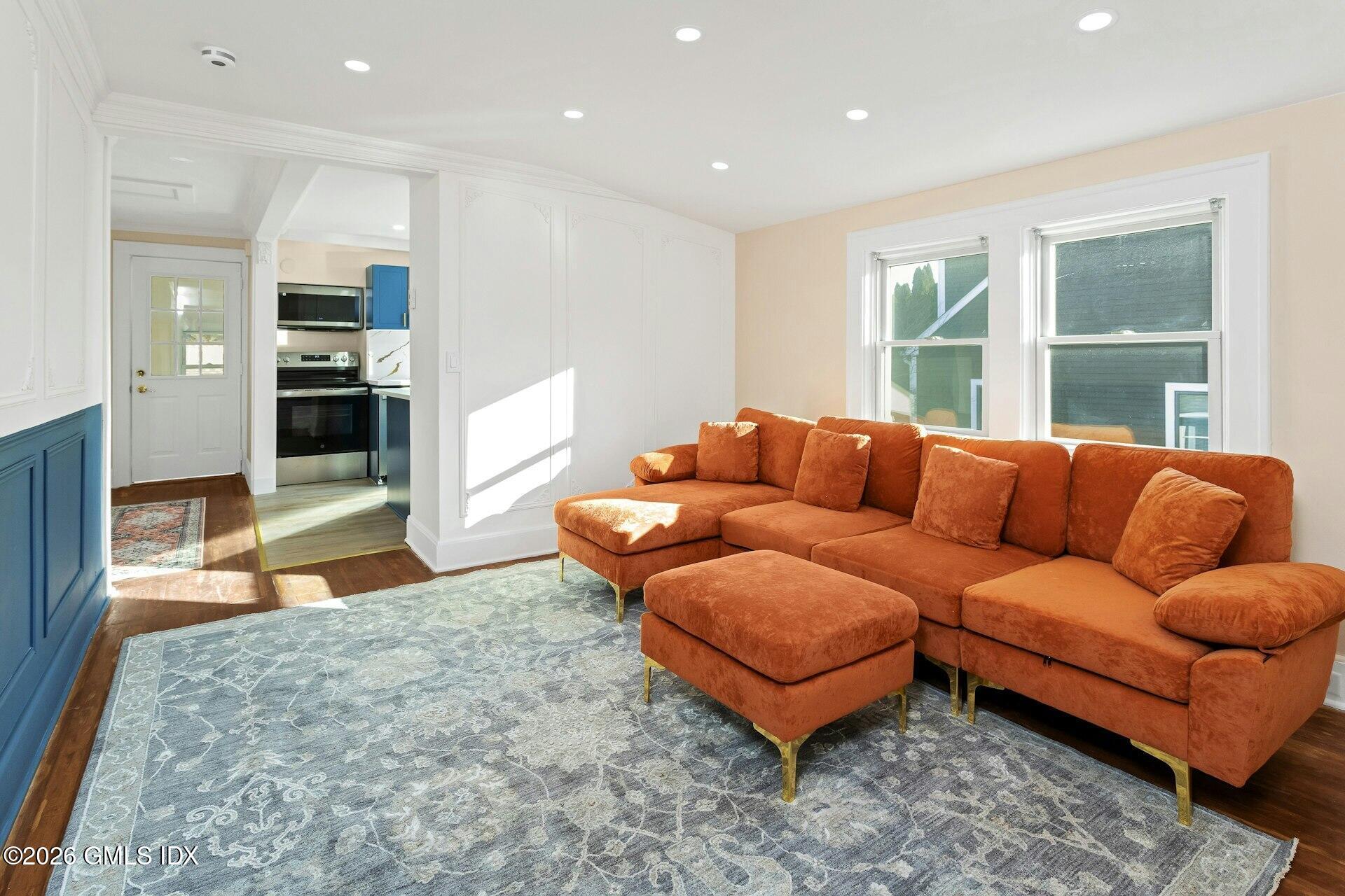 71 Prospect Street, Unit 2 Greenwich, CT 06830 - Photo 9 of 17 a living room with furniture and a large window