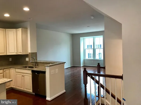 a kitchen with a stove a sink and a window