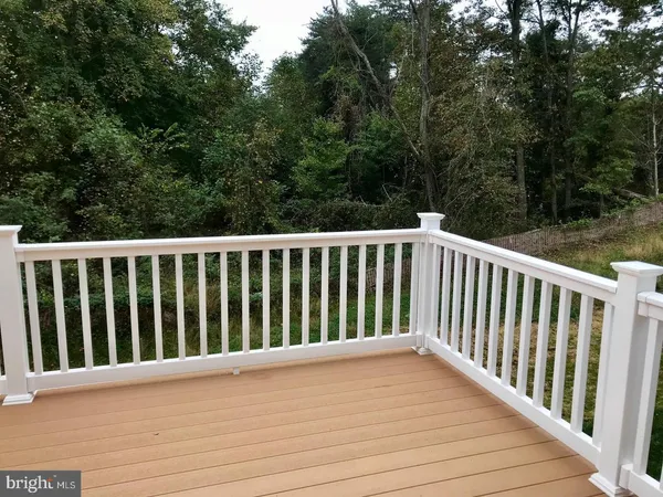 a view of balcony with deck and yard