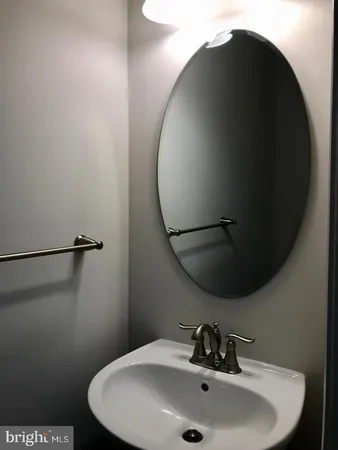 a bathroom with a sink and mirror