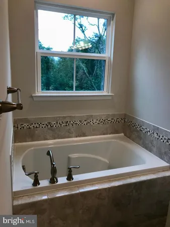 a bath tub sitting next to a window