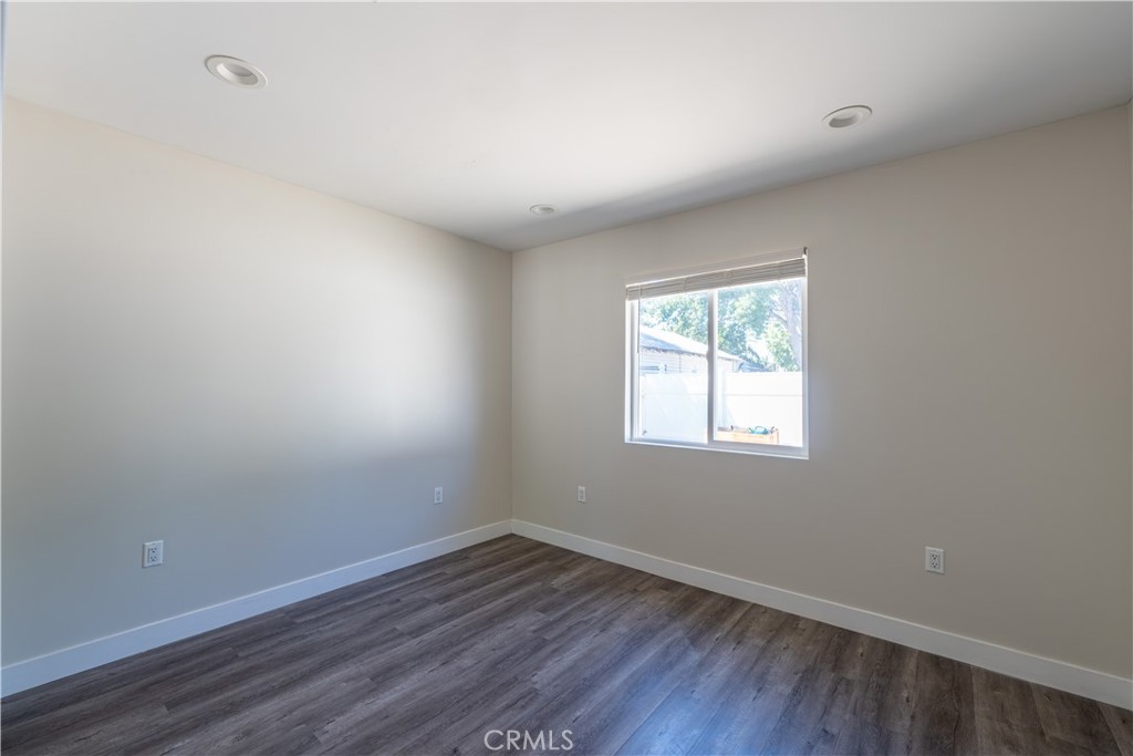 7022 Crebs Avenue Reseda, CA 91335 - Photo 11 of 20 wooden floor in an empty room with a window